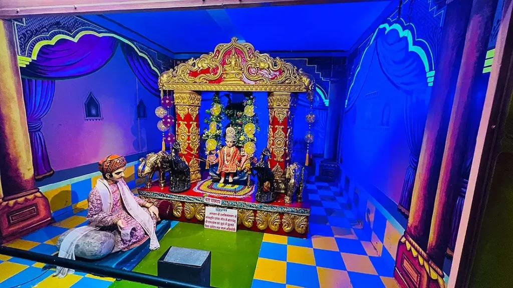 Bal Ghanshyam idol on a jhula diorama inside Gurukul Surat Pradarshan