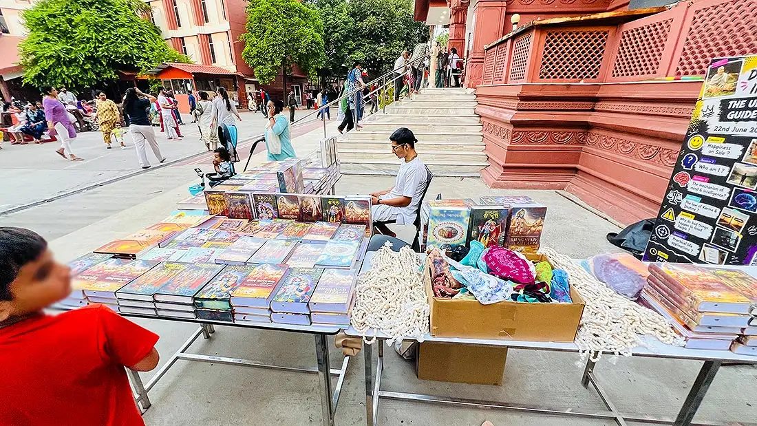 Bhagavad Gita and Krishna books with japa malas at ISKCON Temple book stall near the steps