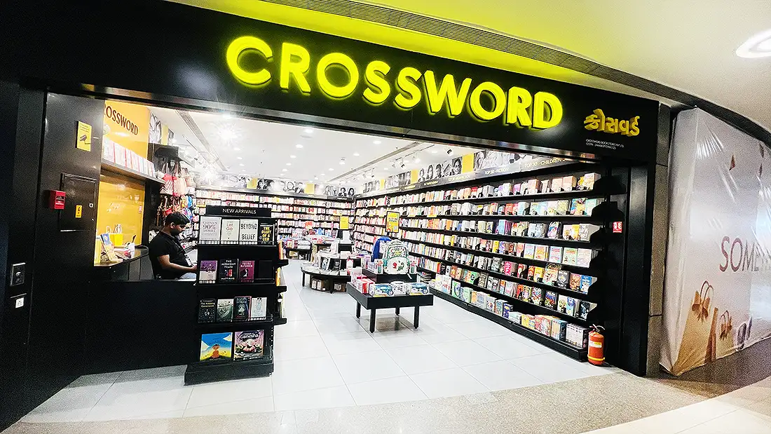 Crossword bookstore inside Surat VR Mall with yellow signage and shelves full of books and a new arrivals stand