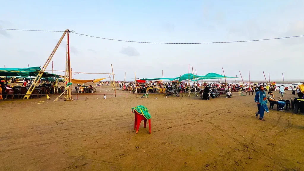 Sandy entrance of Dumas Beach Surat with tents and food stalls