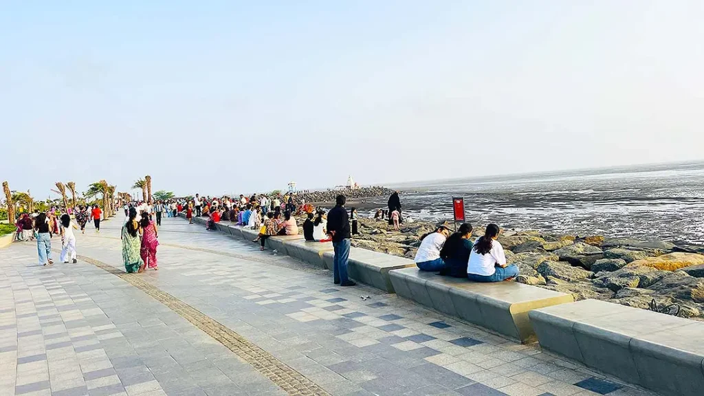 Visitors sitting and walking along Dumas Sea Face Surat promenade