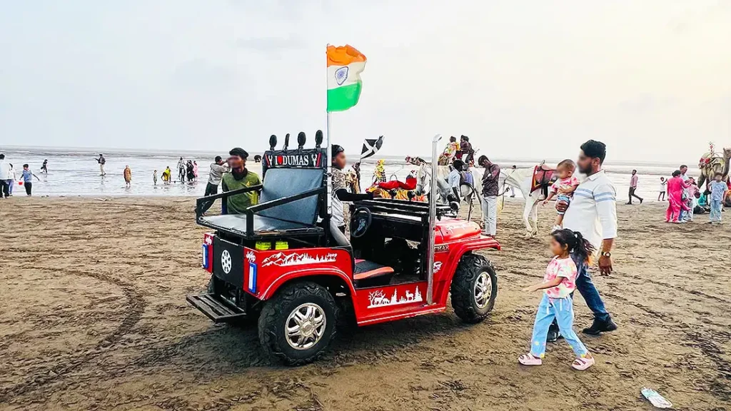 Red I Love Dumas toy jeep at Dumas Beach Surat