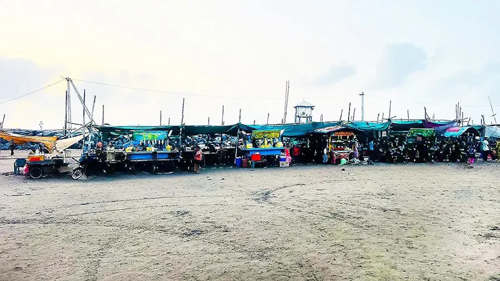 Row of food stalls on the sand at Dumas Beach Surat