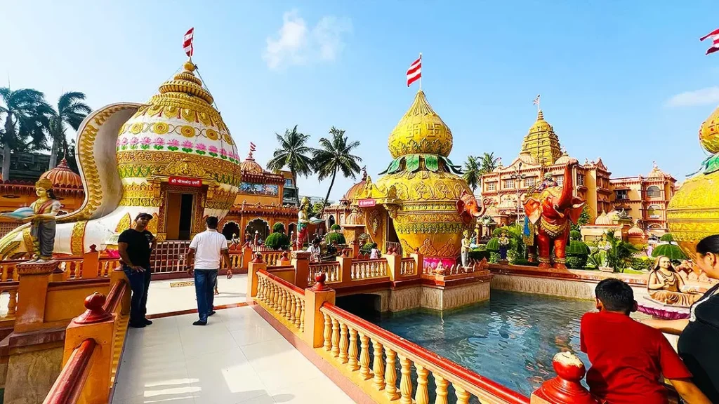 Golden and white kalash shaped domes with elephant statues at Gurukul Surat