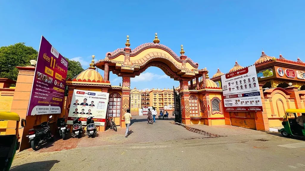 Ornate yellow and pink entrance gate of Gurukul Surat on Ved Road, Katargam