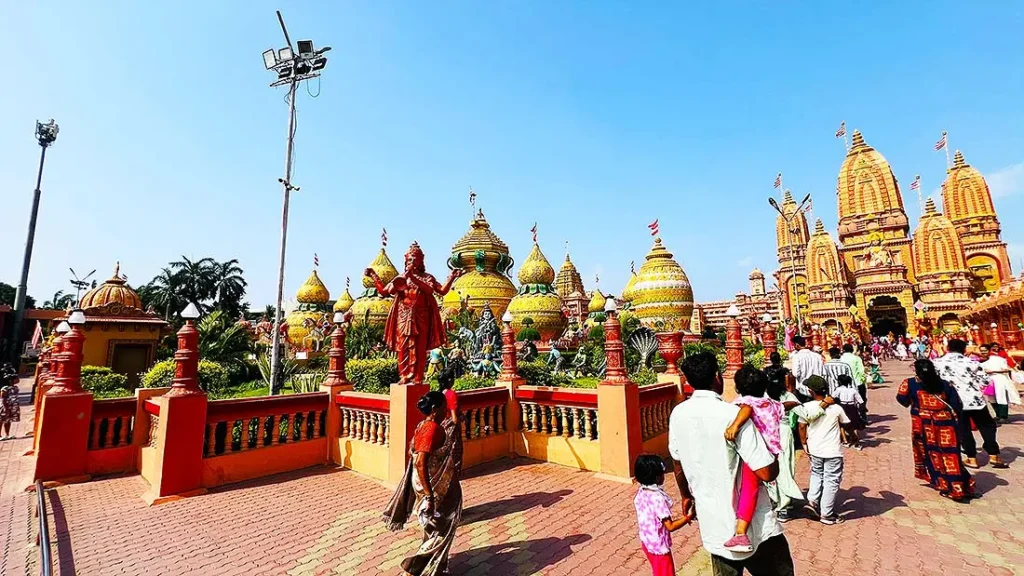 Visitors walking near golden kalash statues and mandir at Gurukul Surat on a Sunday