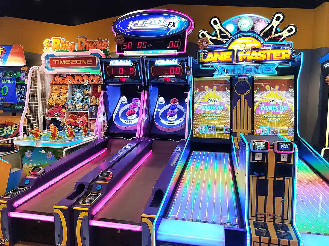 Ice Ball FX and Lane Master Xtreme roller games glowing at Surat VR Mall arcade, with a Ring Ducks game nearby