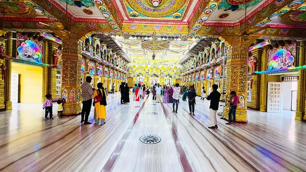 Devotees inside the decorated marble hallway of Swaminarayan mandir at Gurukul Surat