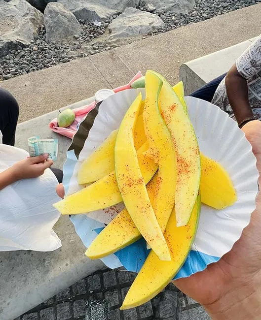 Raw mango slices with red chilli powder at Dumas Sea Face Surat
