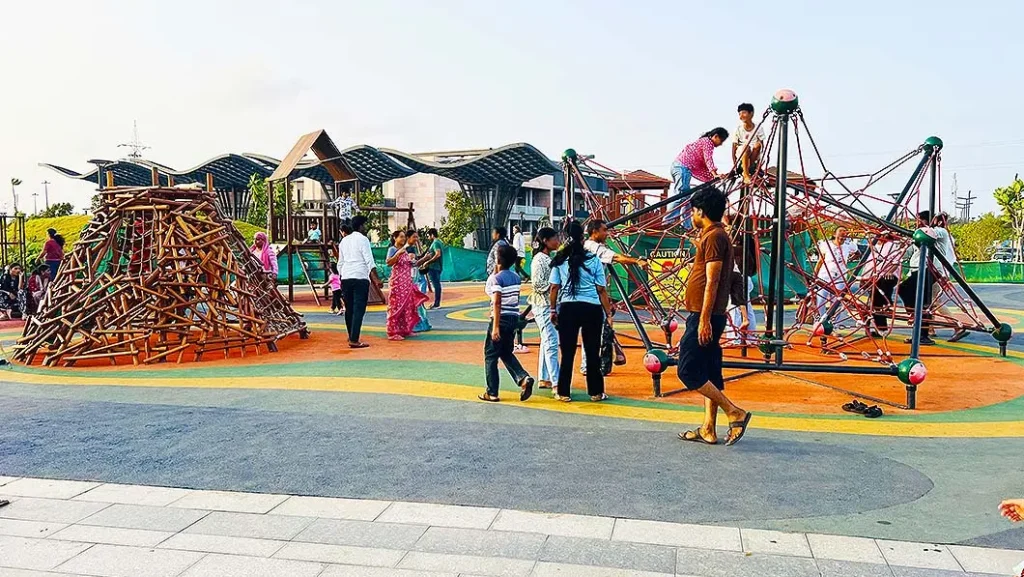 Children playing on climbing structures at Dumas Sea Face Surat play ground