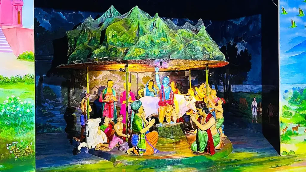 Krishna lifting Govardhan mountain on his finger diorama at Gurukul Surat Pradarshan