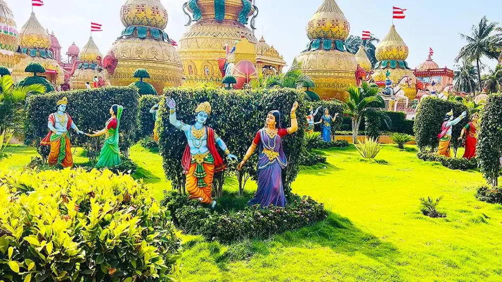 Colourful Krishna and Radha dancing statues in the garden at Gurukul Surat