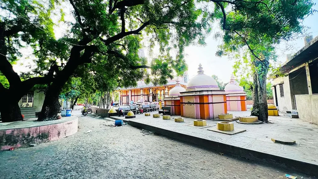 Shaded peaceful courtyard with small shrines at Kurukshetra Mahadev Mandir Surat