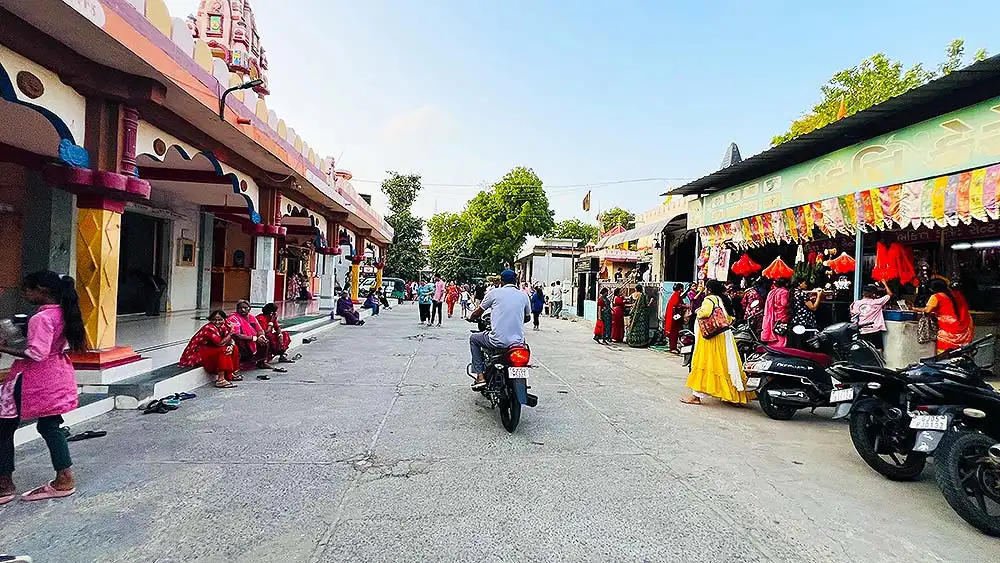 Inside view of Ram Madhi Surat after entry with Sunday crowd, temple and shops visible