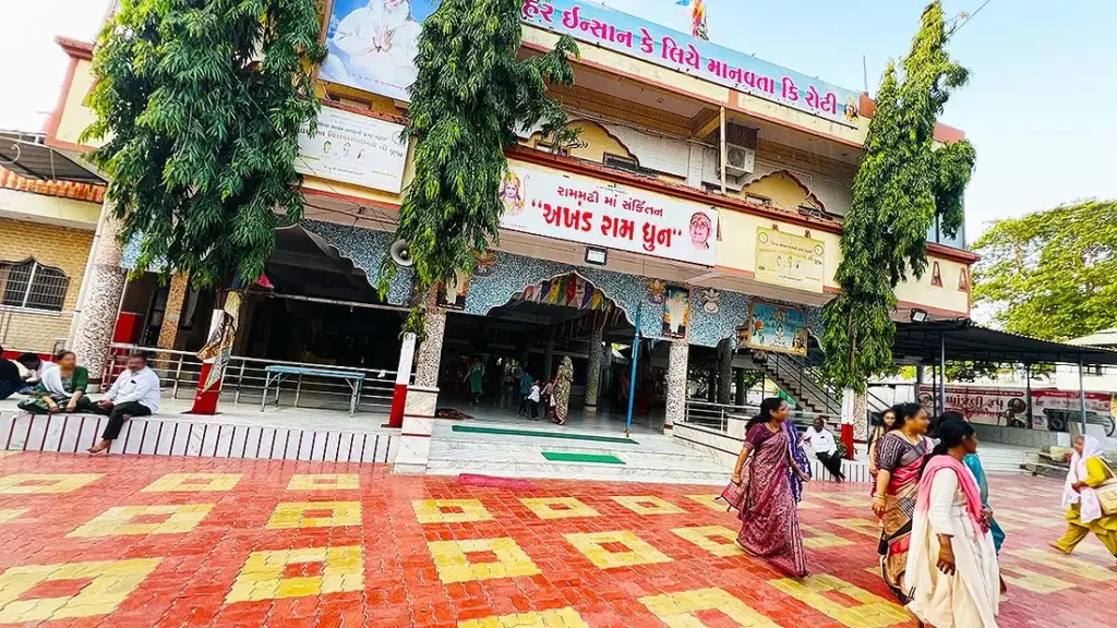 Ramdev Pir mandir outside view at Ram Madhi Surat with Akhand Ram Dhun signboard and devotees