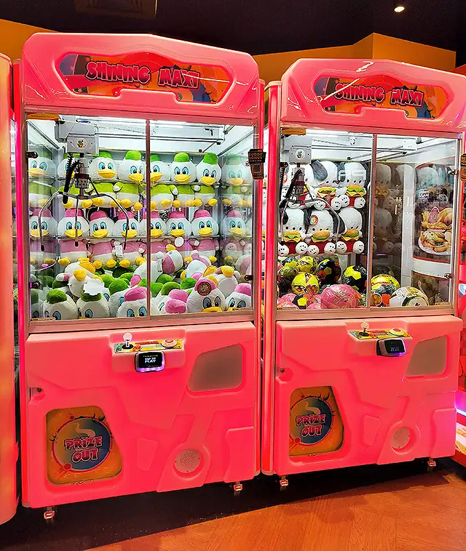 Pink Shining Maxi claw machines at Surat VR Mall arcade, stocked with duck plush toys and prize out slots