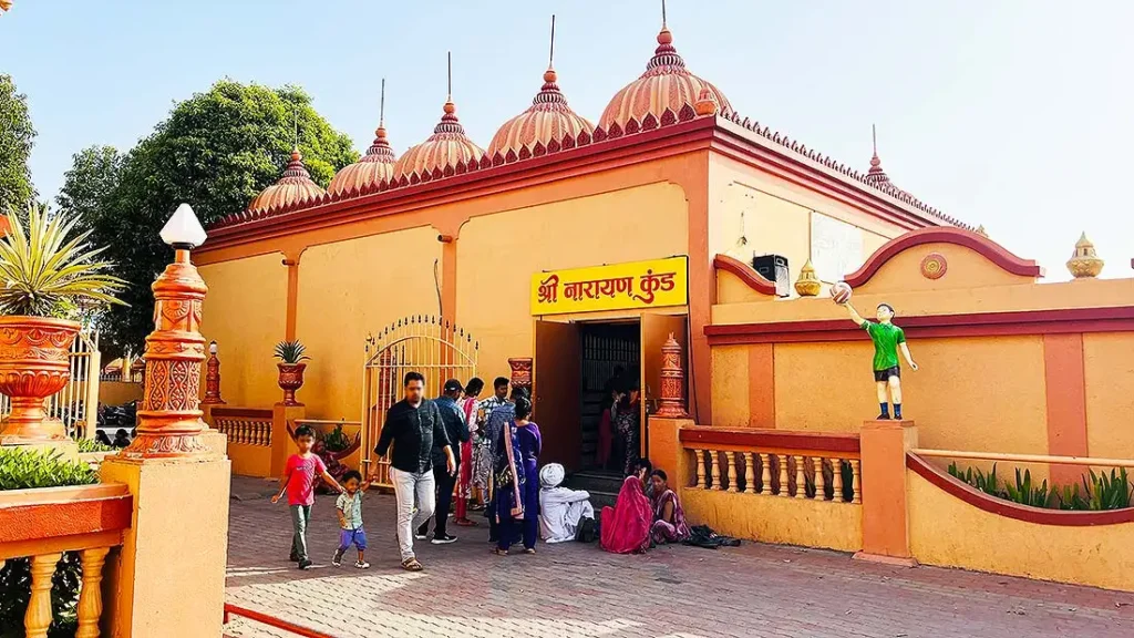 Shree Narayan Kund entrance building with visitors at Gurukul Surat