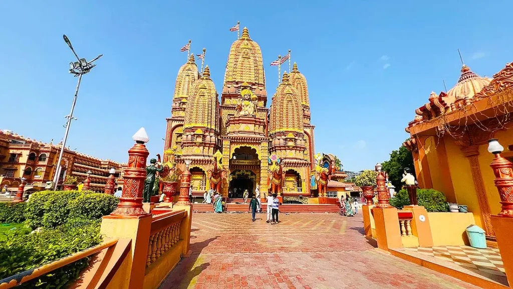 Front view of the golden Swaminarayan mandir at Gurukul Surat with visitors