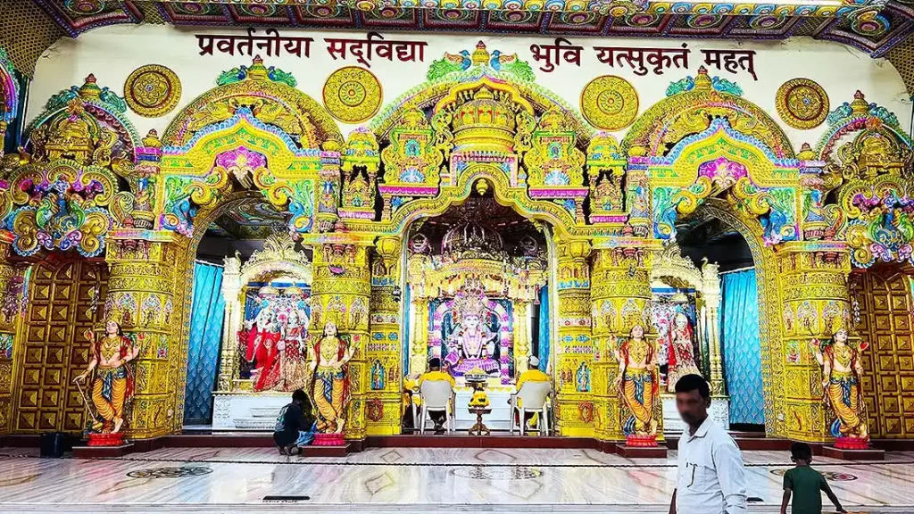 Decorated golden shrine with Swaminarayan idol at Gurukul Surat mandir