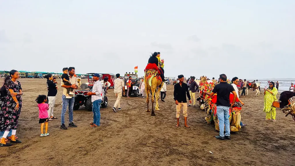 Tourist riding a camel at Dumas Beach Surat